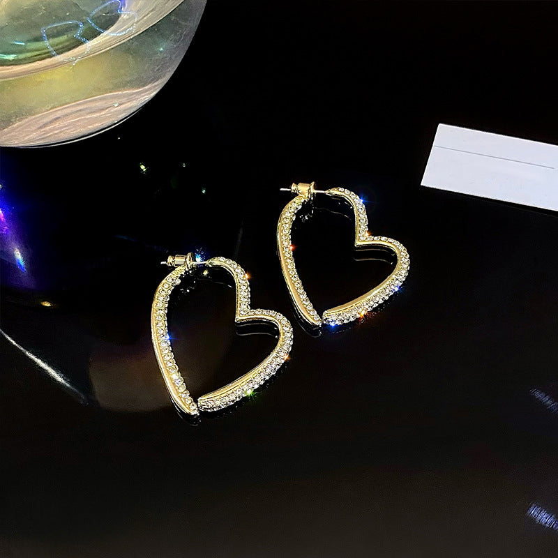 Orecchini a cuore dorati scintillanti da donna
